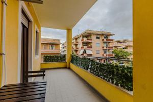 a balcony with a bench and some buildings at Margottini House Airport in Fiumicino
