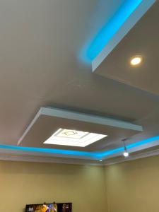 a ceiling with a blue light in a room at Tsavo Apartments Ogembo Deluxe one bedroom apartment in Ogembo