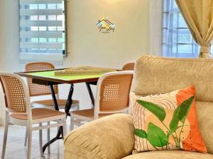 a living room with a couch and a table at 8pax3minsdrivetoJonkerTownArea in Melaka