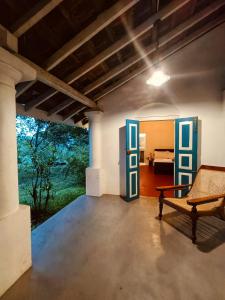a living room with a bench and a bedroom at Lekham Walauwa in Matale +30 photos