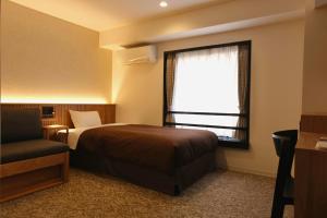 Postel nebo postele na pokoji v ubytování Belmont Hotel