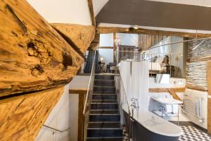 a staircase leading to a bathroom with a wooden wall at Boutique - Hotel Adara in Lindau +30 photos