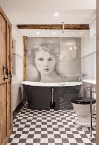 a bathroom with a black and white checkered floor at Boutique - Hotel Adara in Lindau