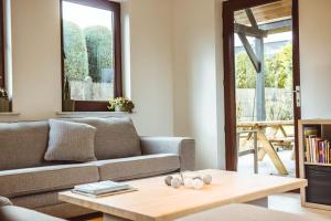 a living room with a couch and a coffee table at Lichtrijke woning aan het Muziekbos in Ronse