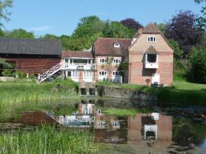 an old building next to a body of water at Salisbury Old Mill House in Salisbury