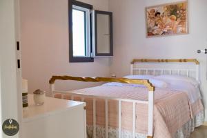 a bedroom with a bed with a mirror and a window at Seaside Apartments in Emporeios