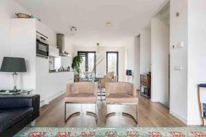 a living room with a couch and a table at 120m2 Spacious 4-bedroom Apartment with Roofterras in Amsterdam