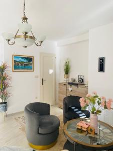a living room with two chairs and a table at Casa Behar in Kotor