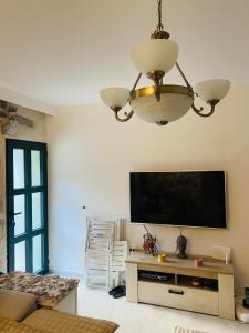 a living room with a flat screen tv on the wall at Casa Behar in Kotor