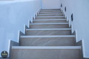 a stairway in a building with concrete steps at Seaside Apartments in Emporeios