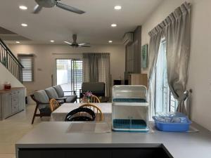 a kitchen and living room with a counter top at Essential Homestay in Tawau - Bandar Sri Indah in Kampong Parit