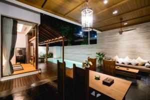 a villa with a pool and a living room at Malisa Villa Suites - SHA Extra Plus in Kata Beach