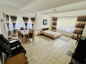 a living room with a bed and a table at Spa Park Guest Rooms in Długopole-Zdrój