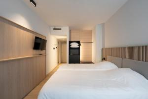 Ένα ή περισσότερα κρεβάτια σε δωμάτιο στο Parkhotel Izegem