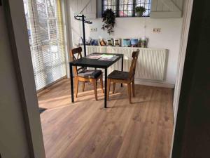 a dining room with a table and two chairs at Studio Bloemenboerderij-Aperloo in 't Harde