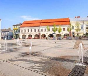 a city square with fountains in front of a building at Nowy Paris in Kielce