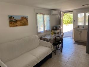 a living room with a couch and a table at T2 Rez de jardin 35 m2 in Balaruc-le-Vieux