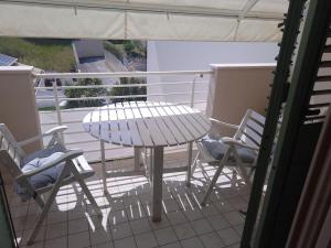 a table and chairs on a balcony with a table and chairs at Octopus house in Civitanova Marche