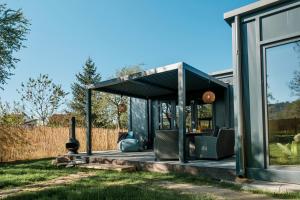 a small house with a green roof on a lawn at 99 Maison by Noire - Deluxe Bungalow Sibiu -Adults Only in Sibiu