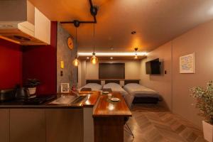 a kitchen and a living room with a bed at おやど紀伊国屋玉園町 in Asahimachi