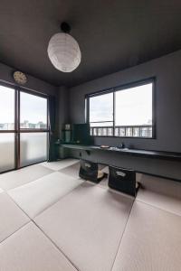 a room with a pool table and two windows at おやど紀伊国屋玉園町 in Asahimachi
