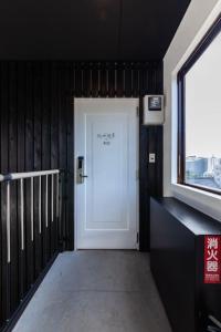 a white door in a room with a window at おやど紀伊国屋玉園町 in Asahimachi