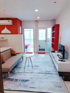 a living room with a couch and a table at Straits Garden Suites Georgetown Penang 1BRcondo in George Town