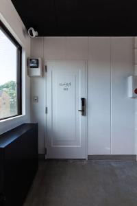 a room with a white door and a window at おやど紀伊国屋玉園町 in Asahimachi