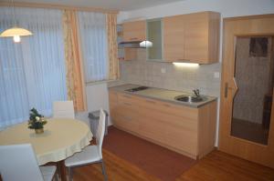 a kitchen with a table and a sink and a table and chairs at Apartment Jakelj in Kranjska Gora +36 photos
