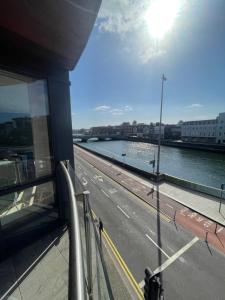 a view of a river from a balcony of a building at Fabulous and Sunny 2 bed Apartment, in City Centre in Cork