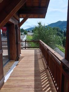 a wooden walkway on a porch of a house at Chalet EMY in Praz-sur-Arly