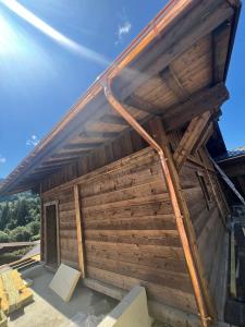 a large wooden building with a roof at Chalet EMY in Praz-sur-Arly