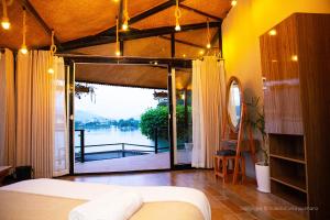 una camera con letto e vista sul lago di The Hideout Villa Pokhara a Pokhara