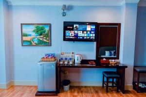 a blue room with a bar with a counter and stool at Linh Phuong 3 Hotel in Can Tho