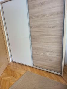 a sliding door in a room with a wooden floor at Ace in Vodno
