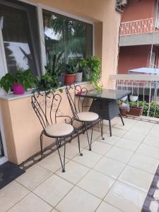 a table and chairs on a patio with plants at Ace in Vodno