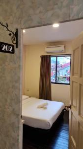 Postel nebo postele na pokoji v ubytování Jade Guesthouse Jonker Melaka