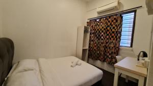 Postel nebo postele na pokoji v ubytování Jade Guesthouse Jonker Melaka