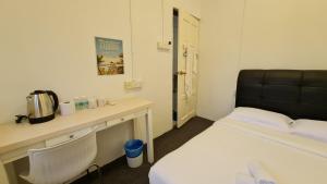 Postel nebo postele na pokoji v ubytování Jade Guesthouse Jonker Melaka