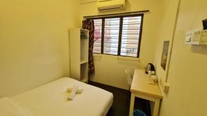 Postel nebo postele na pokoji v ubytování Jade Guesthouse Jonker Melaka