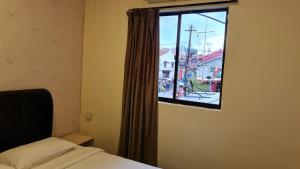 Postel nebo postele na pokoji v ubytování Jade Guesthouse Jonker Melaka