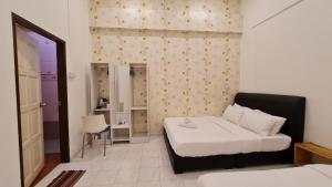 Postel nebo postele na pokoji v ubytování Jade Guesthouse Jonker Melaka