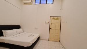 Postel nebo postele na pokoji v ubytování Jade Guesthouse Jonker Melaka