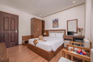 Postel nebo postele na pokoji v ubytování De Lamour Hotel Da Nang