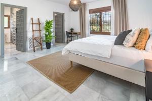 a bedroom with a large bed and a table at GRR - Elegant Villa with Exclusive Private Pool in Marbella +66 photos
