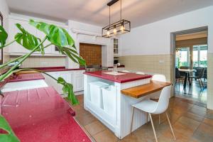 a kitchen with a island with a red counter top at GRR - Elegant Villa with Exclusive Private Pool in Marbella