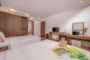 Postel nebo postele na pokoji v ubytování De Lamour Hotel Da Nang