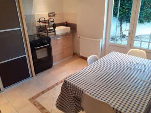 a kitchen with a table and a stove and a table and chairs at Appartement Agen centre in Agen