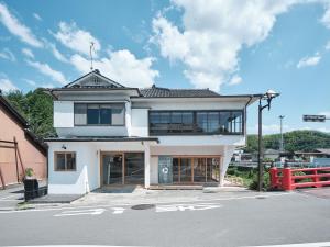 a large white building with a lot of windows at 三笠館Mikasakan 本館 in Kinokawa