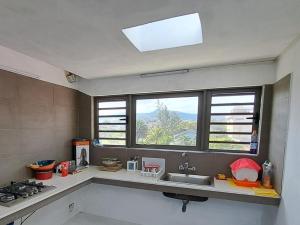 a kitchen with a sink and a window at Gris Gris Studio 2 in Souillac